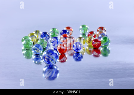 Many colourful marbles on a reflective surface for a background use Stock Photo