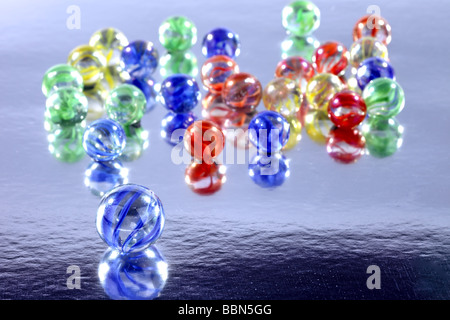 Many colourful marbles on a reflective surface for a background use Stock Photo