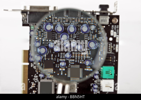 Circuit board with a section magnified showing components Stock Photo