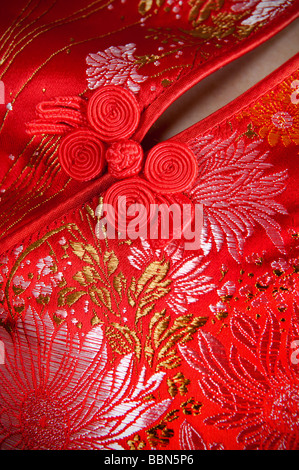 Red knot buttons on silk dress Cheongsam with beautiful patterns, is a Chinese traditional clothes Stock Photo