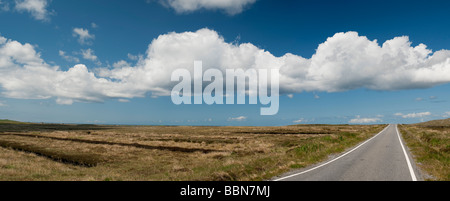 Straight road in the barren landscape of South Uist, Outer Hebrides, Scotland. Panoramic Stock Photo