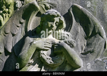 Gravestone Of Angel Holding Wreath In Flaybrick Memorial Cemetery Gardens, Bidston Hill, The Wirral, Merseyside, England, UK Stock Photo