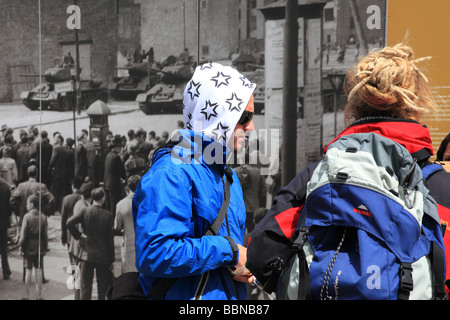 Check Point Charlie  Picture exhibition and two youn people looking at the old pictures Berlin Germany Europe Stock Photo