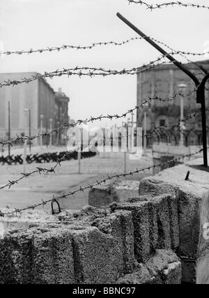 View through barbed wire of the Berlin Wall looking into East Berlin at ...