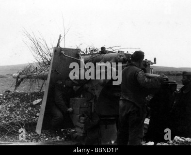 events, Second World War / WWII, Russia 1944 / 1945, Crimea, Sevastopol, German 88 mm anti-aircraft gun Flak 36/37 in firing position against ground targets, assistant gunner loading, 30.4.1944, Eastern Front, USSR, Wehrmacht, Luftwaffe, AA, guns, artillery, emplacement, gunners, gunner, shell, shield, 20th century, historic, historical, Soviet Union, soldiers, crew, 8.8 cm, people, 1940s, Stock Photo