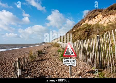 Red danger triangle warning sign for Unstable cliffs at Dunwich on the Suffolk Coast Stock Photo