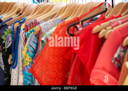 Women's T-shirts Or Dresses Hang On Hangers In A Clothing Store. Close 