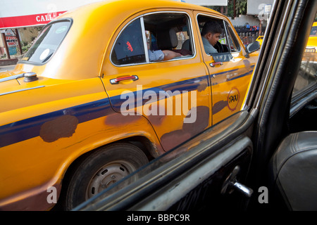 Yellow taxis viewed from inside a yellow taxi, Kolkata, India Stock Photo