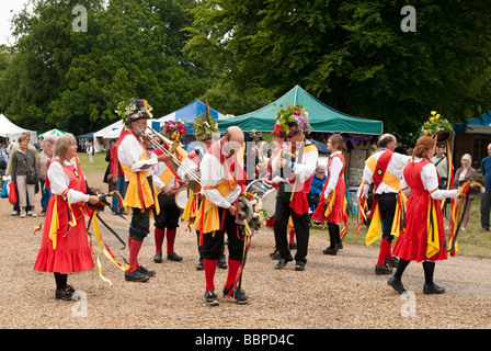 Traditional morris dancers (Knockhundred Shuttles Clog Morris) in full dress and hats at a country garden show Stock Photo