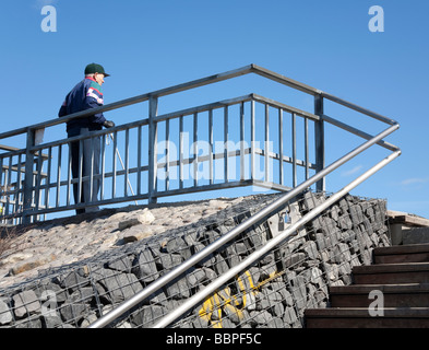 Senior man resting at the top of the stairs , Finland Stock Photo