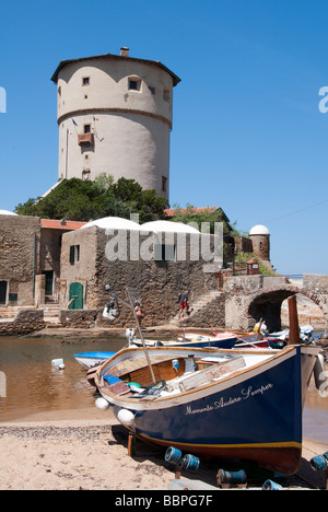 A 'gozzo', pulled up onto the sand at the beach of Campese in front of the Medici tower on Island of Giglio or Isola del Giglio Stock Photo