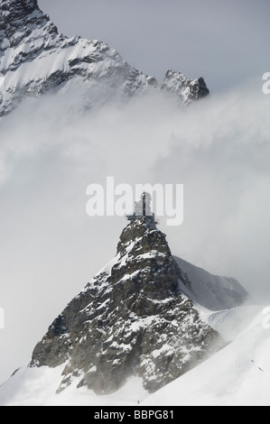 Looking across the Jungfraujoch at the Sphinx Observatory with the Jungfrau in the background Stock Photo