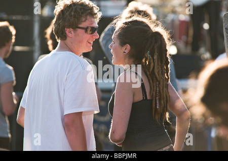 A Young happy backlit couple at the Roc y Castell Castle Rock free music festival Aberystwyth Wales UK 30 May 2009 Stock Photo