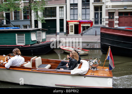 ROMANTIC RIDE ON A BARGE ON THE CANALS, RAAMGRACHT, AMSTERDAM, NETHERLANDS Stock Photo