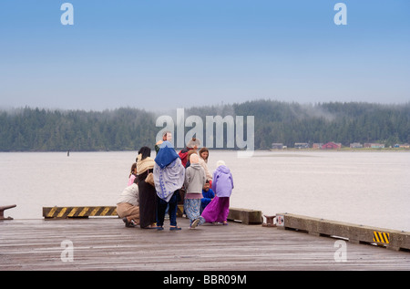 People of different Nationalities on Jetty enjoying view over Pacific Ocean Stock Photo