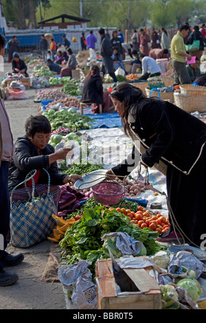 Market traders and shoppers at  Paro vegetables and fruit market, Bhutan, Asia Stock Photo