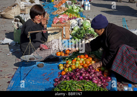 Market traders and scales at Paro vegetables and fruit market, Bhutan, Asia Stock Photo