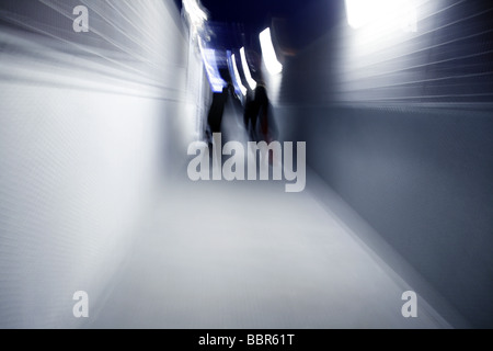 two people walking down dark alley at night Stock Photo