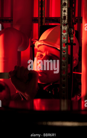 Engineer working on plant room industrial boilers Stock Photo