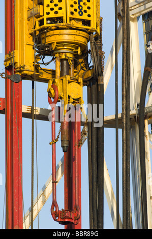 An oil rig drilling derrick showing detail of the Varco top drive ...