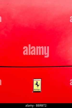 A Ferrari badge on a Red Ferrari bonnet Stock Photo