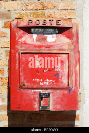 Old red Italian mail box on a wall Stock Photo