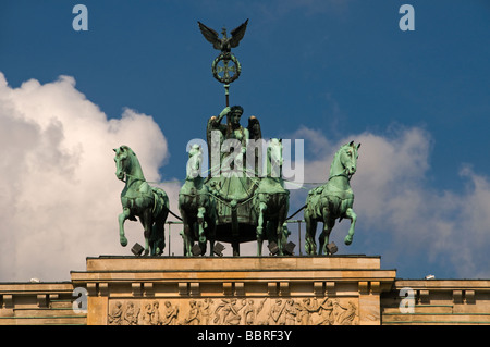 Sculpture showing Quadriga driven by a female figure known as peace designed by Johann Gottfried Schadow atop Brandenburg Gate in Berlin Germany Stock Photo