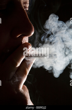 A smoker smokes a Pall Mall cigarette made by British American Tobacco ...