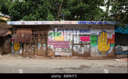 Boarded up shop near the Alleppey backwaters covered in religious and political graffiti Stock Photo