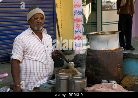 Indian 'Chai-Wallah' ( Tea-Seller ) prepares tea on street-side, Bhachau, Kutch, Gujarat State, India. Stock Photo