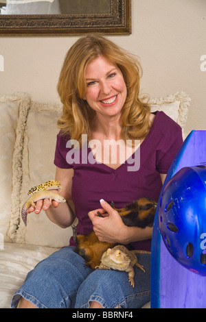 Portrait of mature woman holding animals on couch MR  © Myrleen Pearson Stock Photo