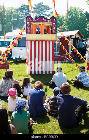 Children and parents watching punch and judy show Abergavenny fair Wales UK Stock Photo