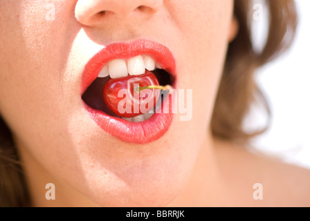 Woman with a cherry in her mouth Stock Photo