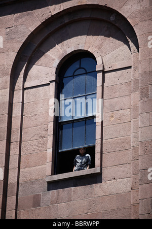 Man looks out window of Arlington Street Church, Boston Stock Photo