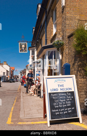 The Lord Nelson pub ( Adnams ) in Southwold Suffolk Uk with customers outside ( award winning best coastal pub ) in the summer Stock Photo