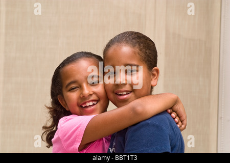 Portrait of two  African American Caucasian sisters hugging MR  © Myrleen Pearson Stock Photo
