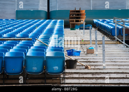 Rows of empty seats in an auditorium with a brush and a bucket in the foreground Stock Photo
