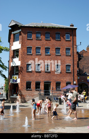 children playing in the quayhead square water fountain near st andrews gardens worcester uk Stock Photo
