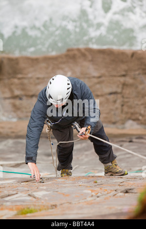 Climbers on a sea cliff climb on Baggy Point near Croyde in north Devon UK Stock Photo