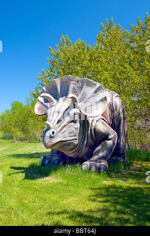 A dinosaur sculpture in a clearing of the bush near East Braintree, Manitoba, Canada. Stock Photo