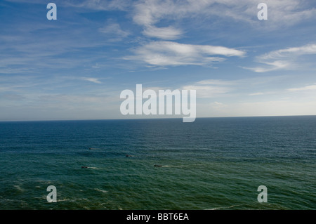 Fishing boat speeding across the water on the horizon in the distance of Indian ocean. Stock Photo