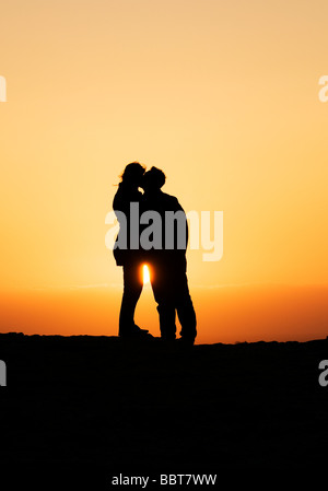 silhouette of a young couple kissing at sunset Stock Photo - Alamy