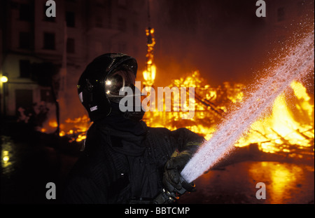 Valencia firemen controlling the fire at the burning of the ninos the Las Fallas festival Stock Photo