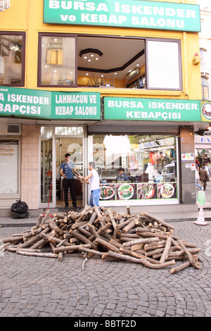 Istanbul Turkey a pile of newly delivered wooden logs outside a kebab kebap cafe the wood is used as charcol fuel in Eminonu Stock Photo
