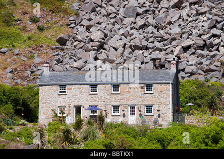 A house at Lamorna cove in Cornwall UK overshadowed by boulders from an