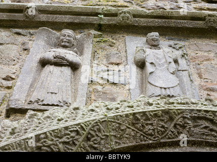 Saint Francis and Saint Patrick at Clonmacnoise Cathedral. Two carved figures of these famous saints above an carved door frame. Stock Photo