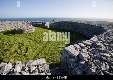 Panoramic View from the High Circular Fort. Two women tourists rest and enjoy the view from the massive circular fort Inishmore Stock Photo