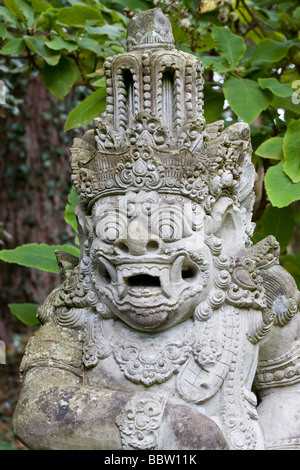 Kala or Bhoma: Balinese Statue. This ornately carved temple guarding statue from Bali Indonesia depicts a leering monster. Stock Photo