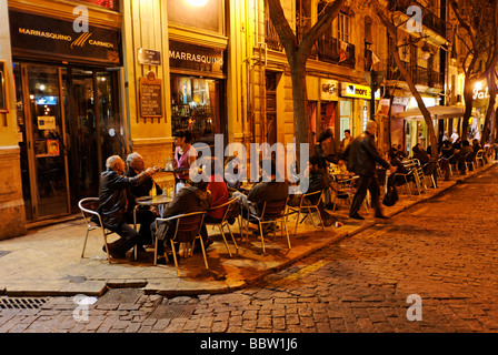 People sitting outside a cafe bar on Plaza Tossal in the historic El Carmen city centre of Valencia Spain Stock Photo