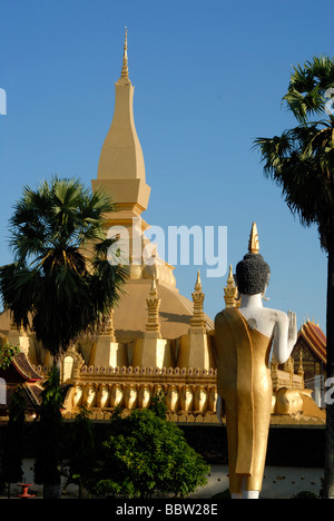 Buddha statue looking towards Pha That Luang, Great Stupa, Vientiane, Laos, Asia Stock Photo